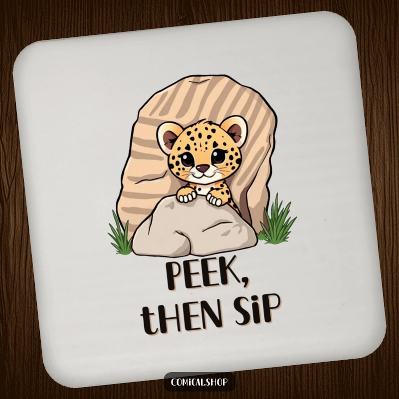Funny cheetah cub peeking from behind a rock on a drink coaster, showing playful curiosity for screen readers.