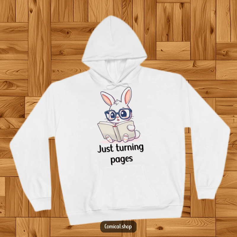 Funny hoodie showing a cute bunny with big glasses, deeply focused on reading an enormous book, embodying intellectual charm.