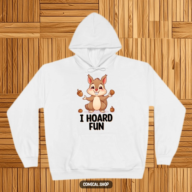 Funny hoodie depicting a delighted squirrel, masterfully juggling numerous acorns with a wide, happy grin.