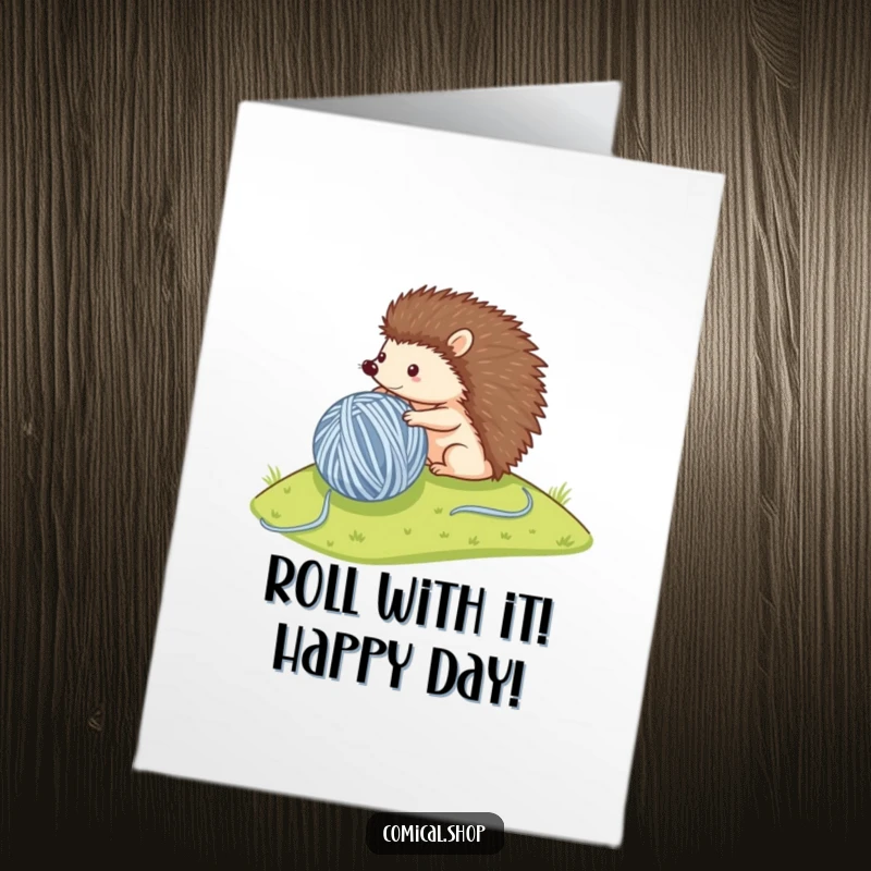 Funny Free Printable Birthday Card: A small hedgehog happily rolls a giant ball of yarn down a hill, celebrating a playful birthday.